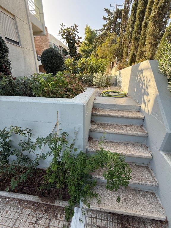 Elegant outdoor staircase leading to a lush garden area.
