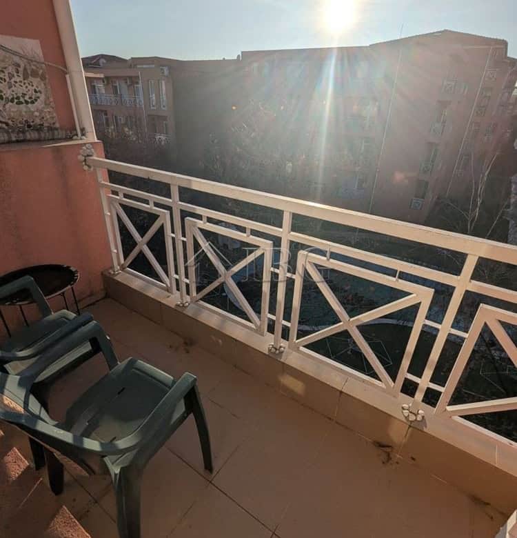 Balcony view from a furnished studio apartment in Sunny Beach, with sunlight and cityscape in the ba.