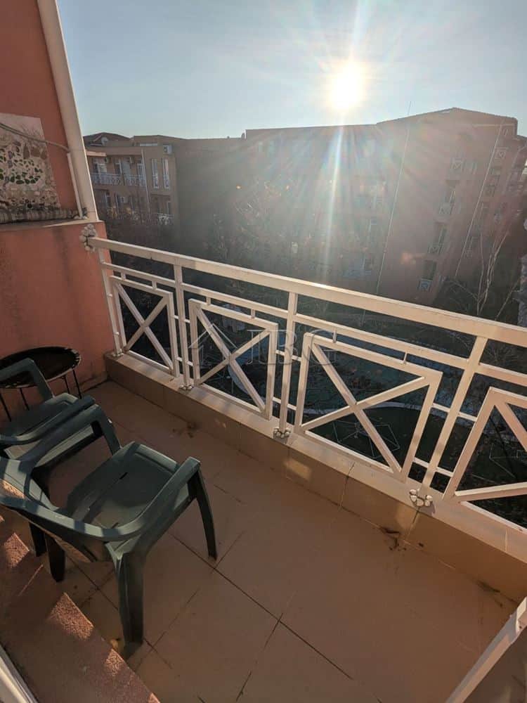Balcony view from a furnished studio apartment in Sunny Beach, with sunlight and cityscape in the ba.