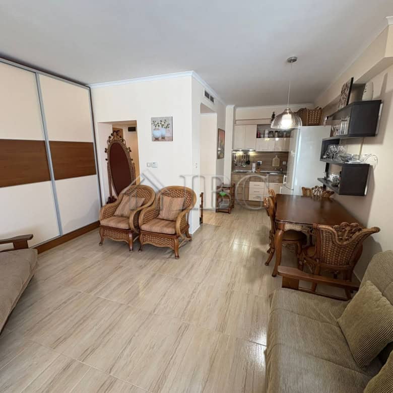 Apartment interior with living area, seating, and kitchen at Majestic Beach Resort, Sunny Beach.