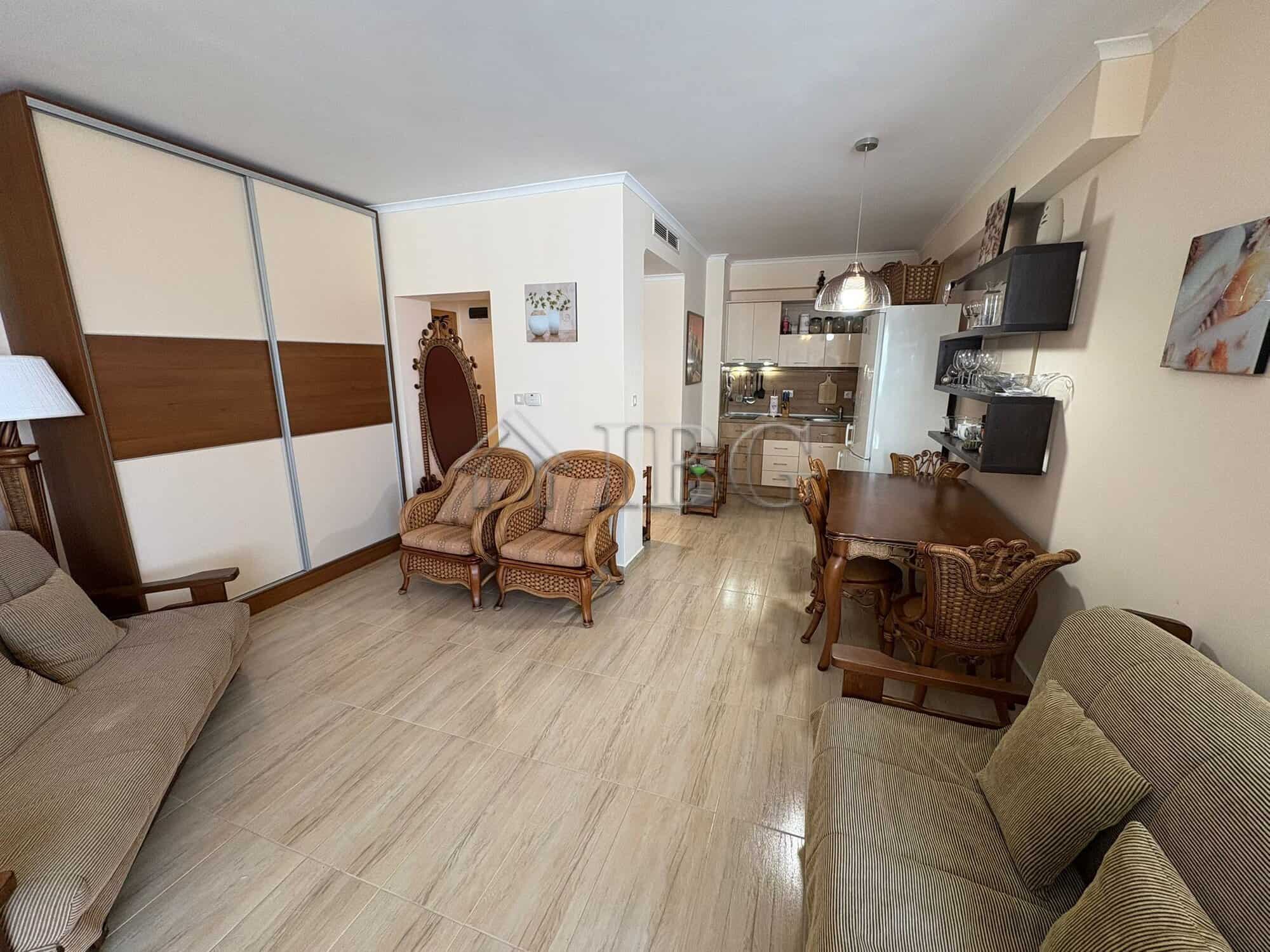 Apartment interior with living area, seating, and kitchen at Majestic Beach Resort, Sunny Beach.