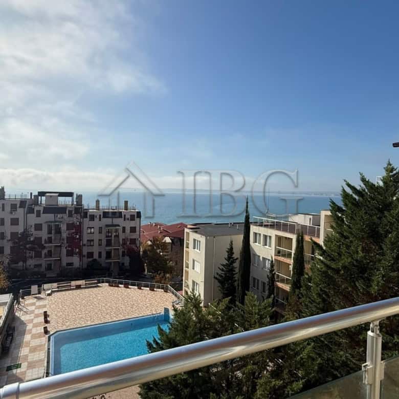 Bright 2-bedroom apartment with sea view in Sveti Vlas, Bulgaria, overlooking the coastline and pool.