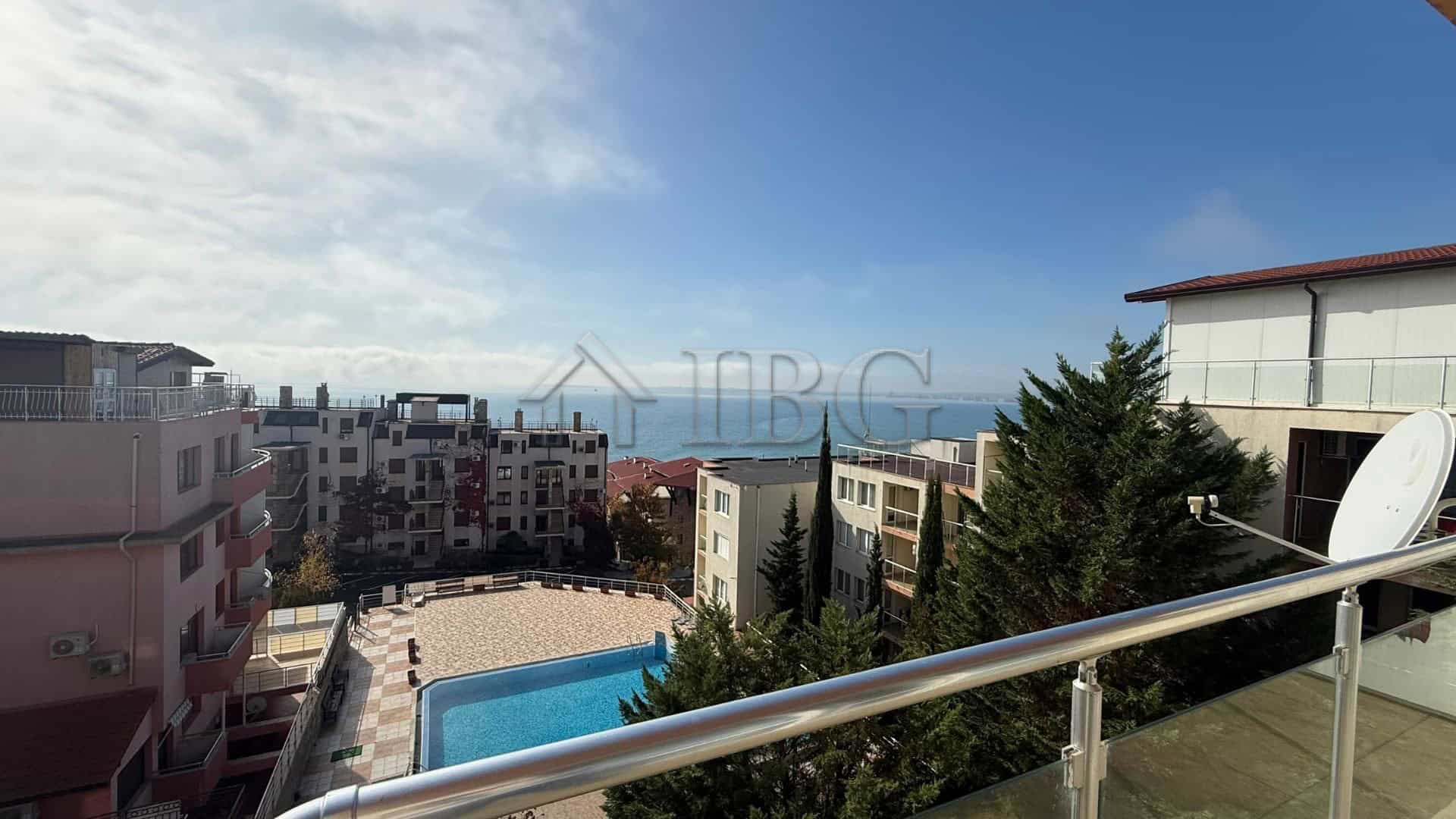 Bright 2-bedroom apartment with sea view in Sveti Vlas, Bulgaria, overlooking the coastline and pool.