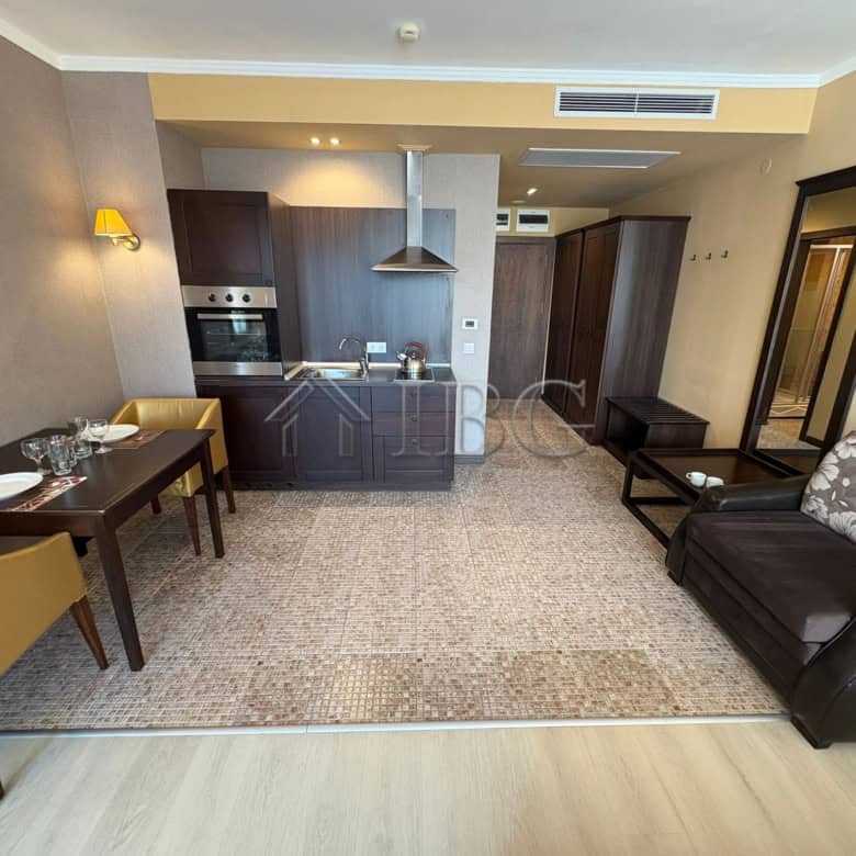 Modern studio apartment with pool view, open-plan kitchen, and living area in Sunny Beach.