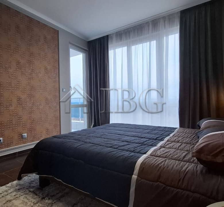 Bright and modern 2-bedroom apartment in Nessebar with large windows and stylish decor.
