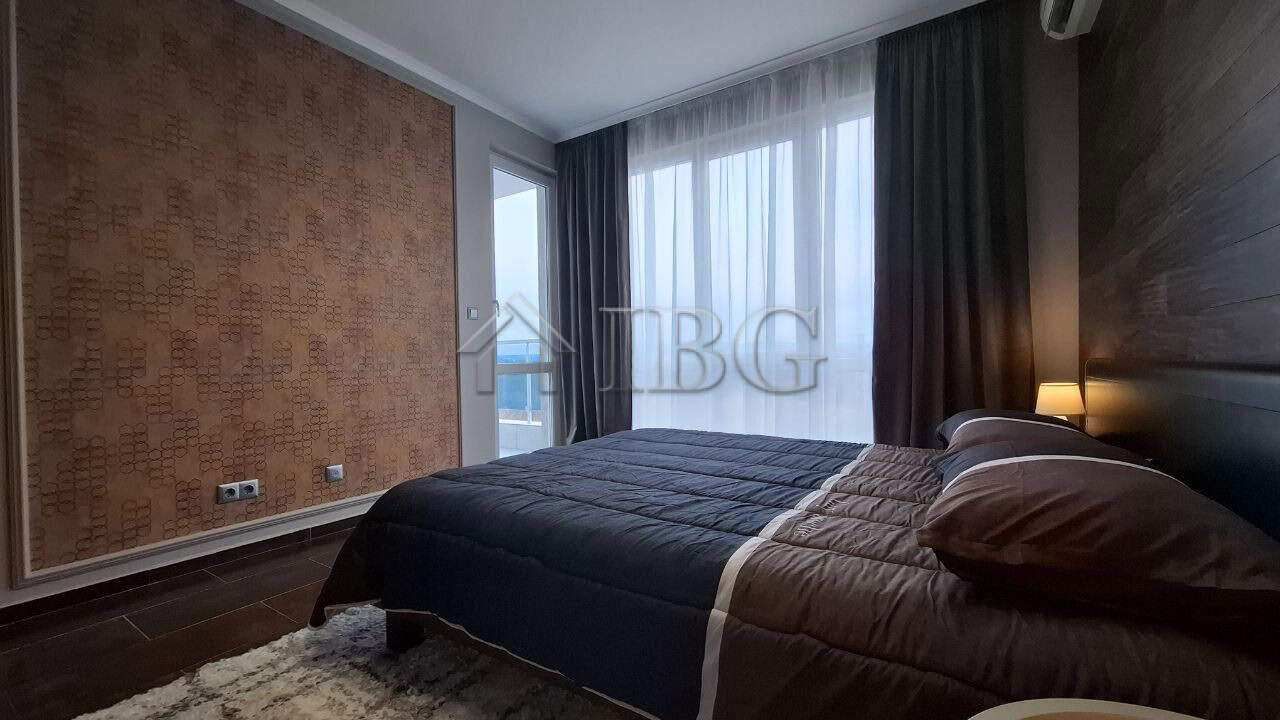 Bright and modern 2-bedroom apartment in Nessebar with large windows and stylish decor.