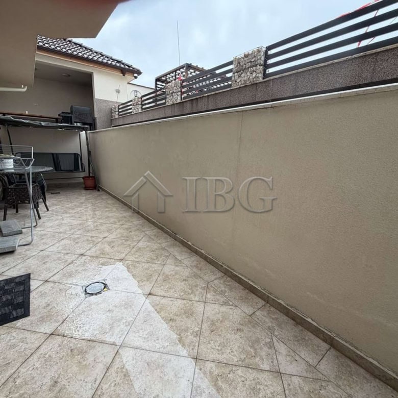 Spacious terrace of a new one-bedroom apartment in Kosharitsa with outdoor seating.