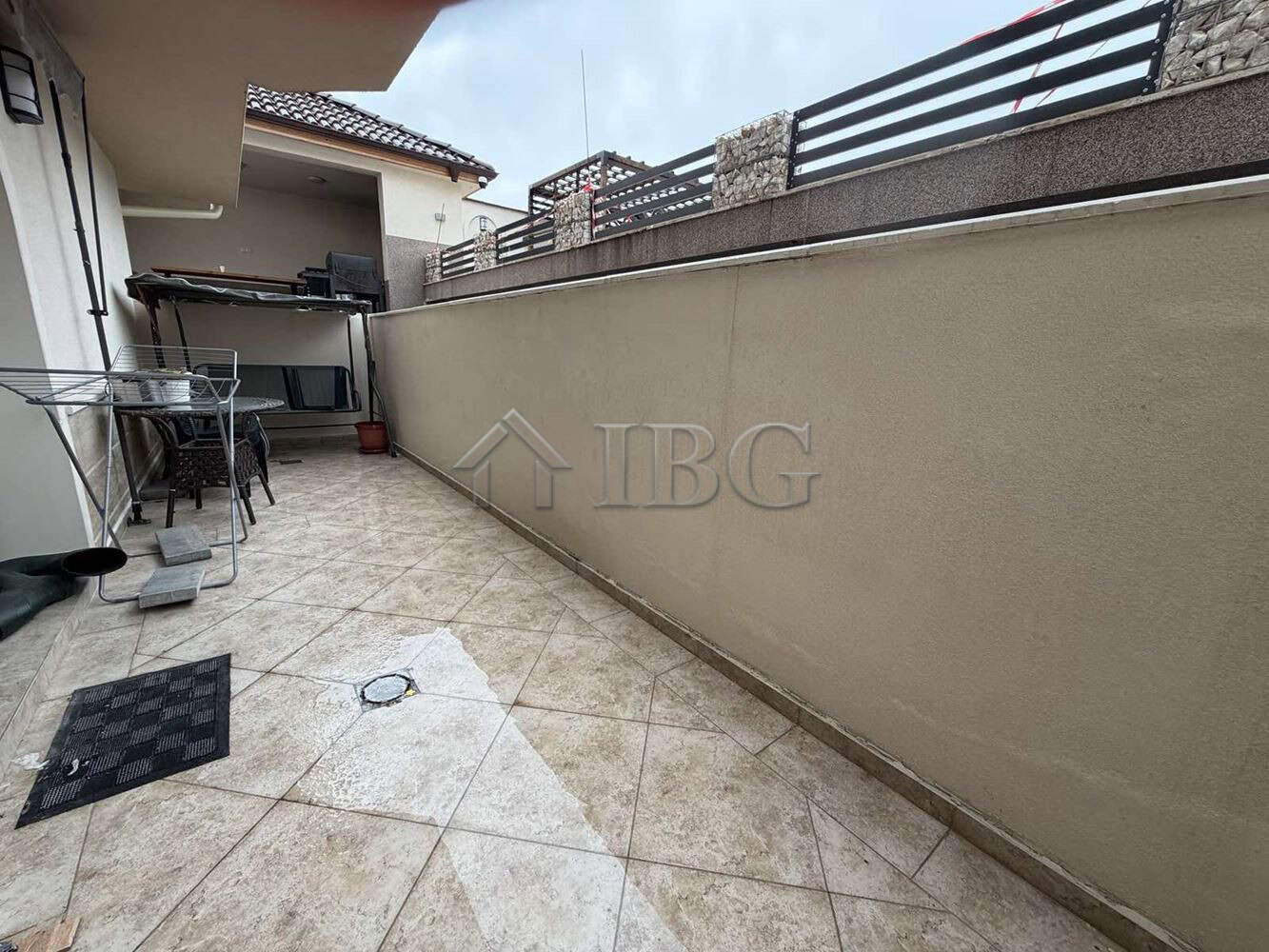 Spacious terrace of a new one-bedroom apartment in Kosharitsa with outdoor seating.