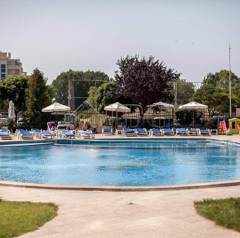 Bright outdoor swimming pool at a sunny holiday apartment complex in Sunny Beach.