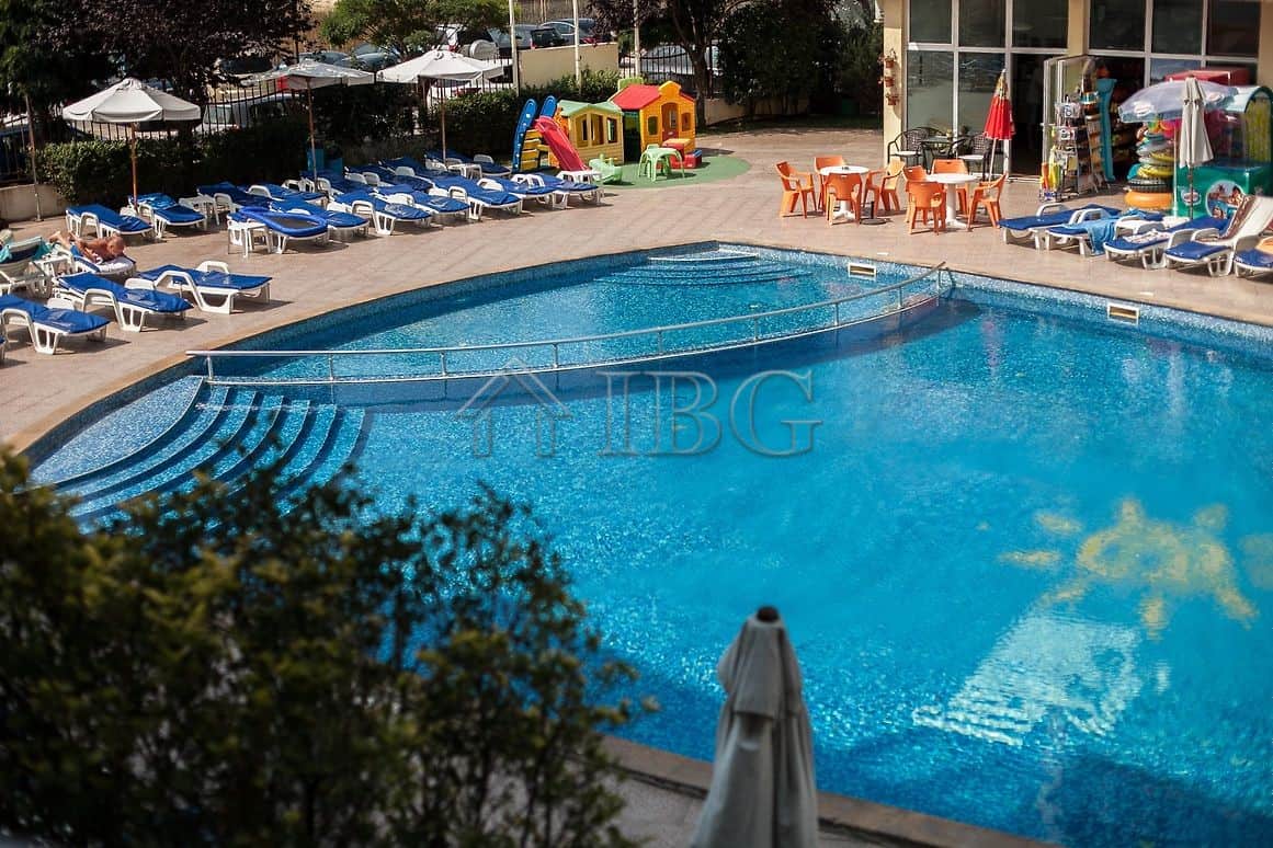 Outdoor swimming pool at Sunny Beach with sun loungers and children’s play area.