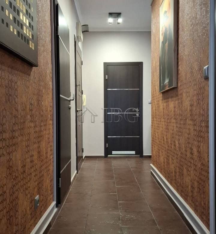 Modern hallway in a 2-bedroom apartment with stylish decor and lighting.