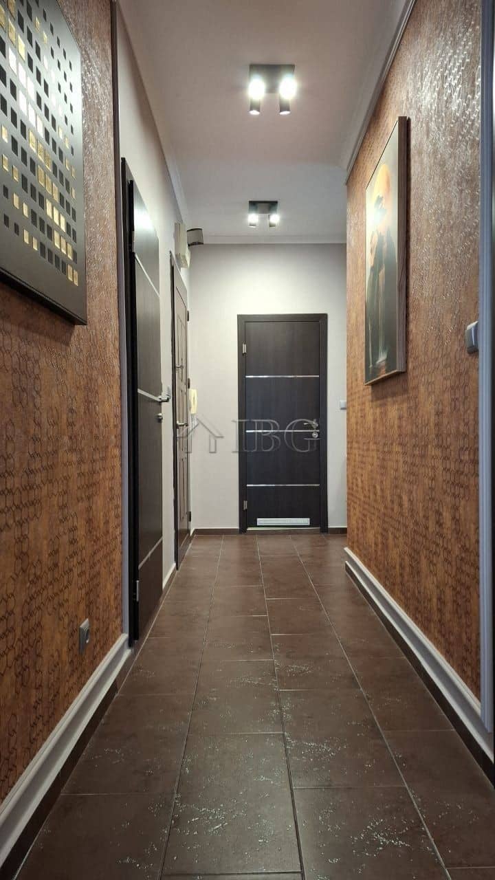 Modern hallway in a 2-bedroom apartment with stylish decor and lighting.
