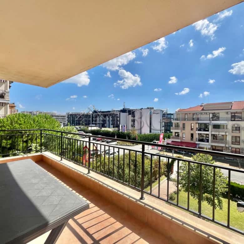 Spacious balcony overlooking Sveti Vlas with cityscape and clear blue sky.