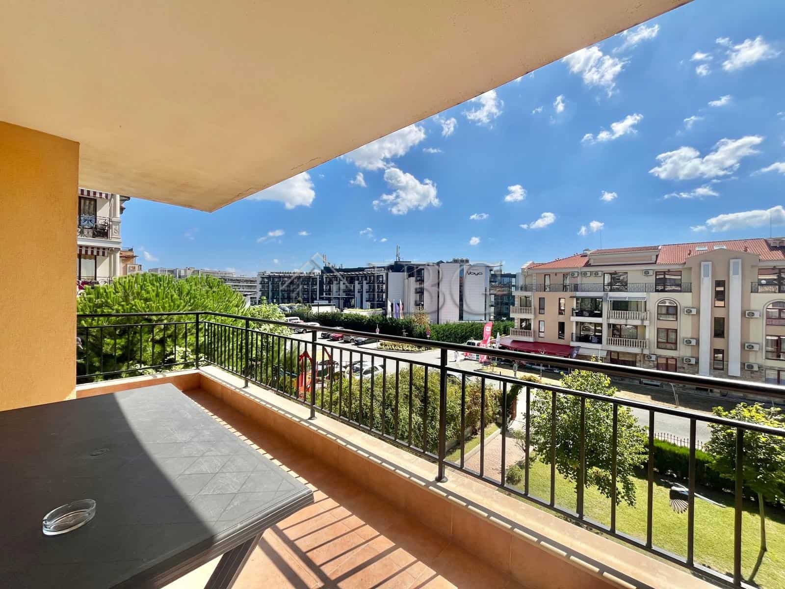 Spacious balcony overlooking Sveti Vlas with cityscape and clear blue sky.