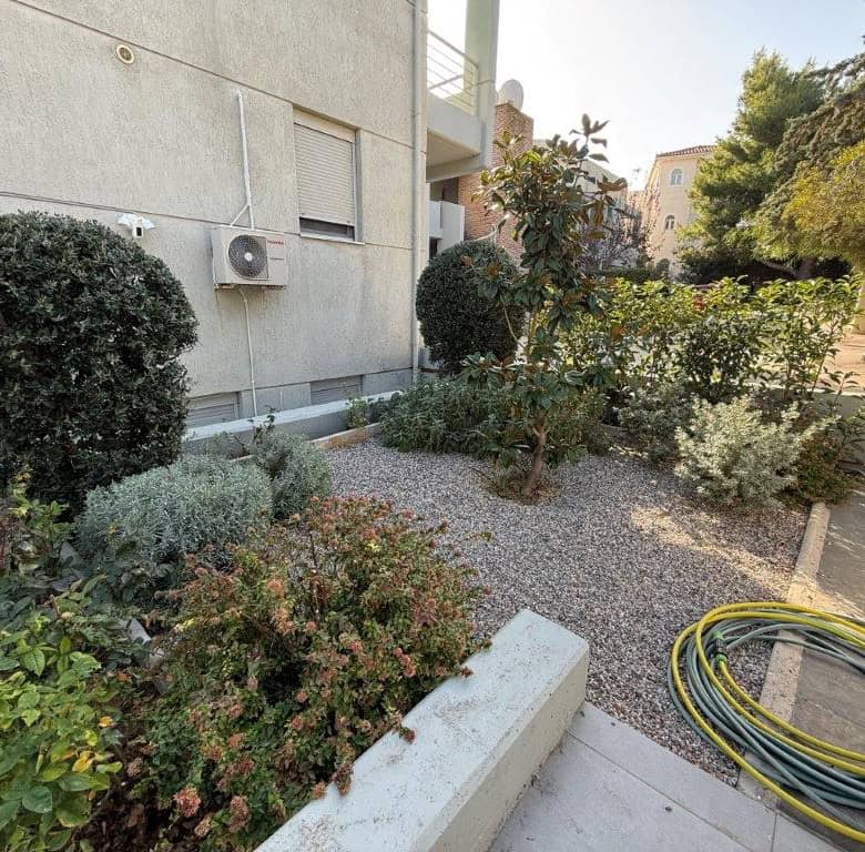 Spacious outdoor garden area of a luxury 3-bedroom home in Neos Voutzas, Attica, Greece.