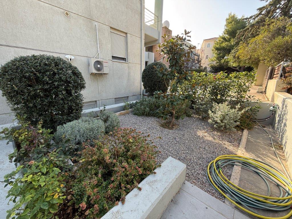 Spacious outdoor garden area of a luxury 3-bedroom home in Neos Voutzas, Attica, Greece.