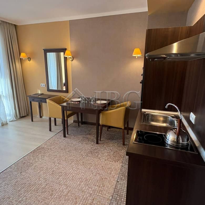 Spacious studio apartment featuring a pool view, modern kitchenette, and stylish decor at Royal Beac.