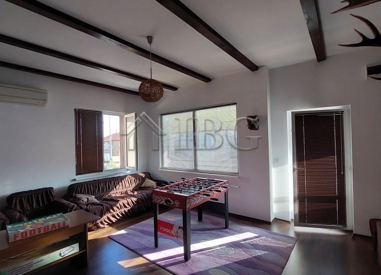 Bright living room with large windows and cozy furniture in a family house in Burgas.