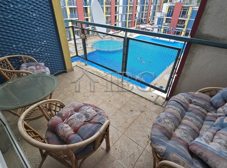 Balcony of a two-bedroom apartment overlooking a swimming pool at Elite 4 Complex, Sunny Beach.