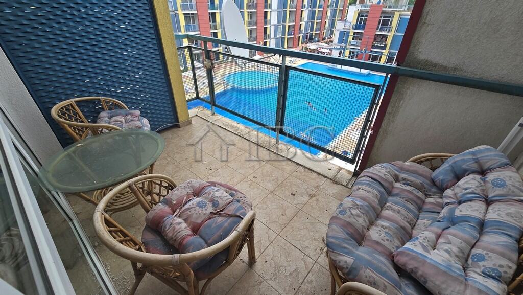 Balcony of a two-bedroom apartment overlooking a swimming pool at Elite 4 Complex, Sunny Beach.
