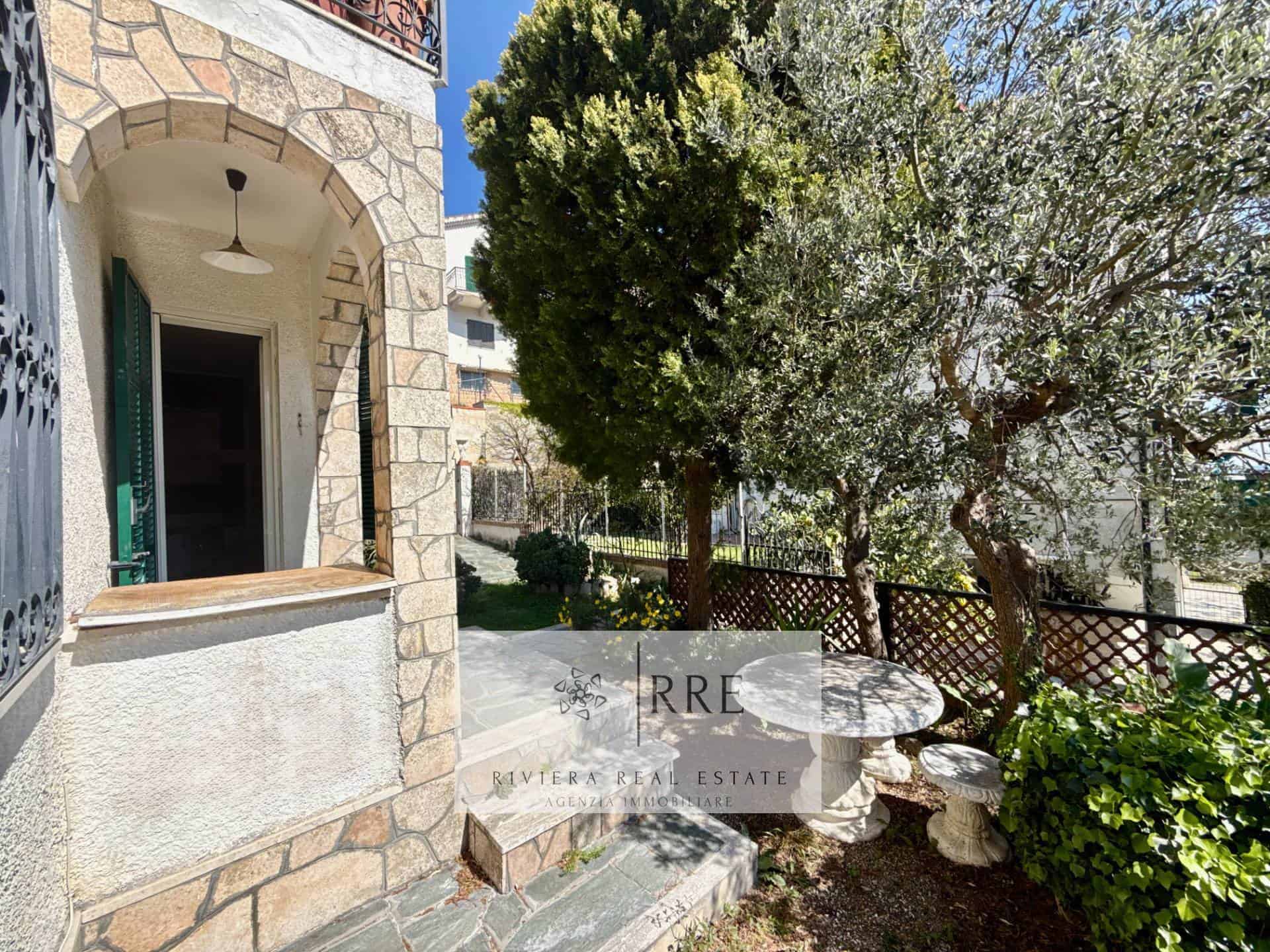 Beautiful outdoor garden with stone table and lush greenery in a Mediterranean-style property.
