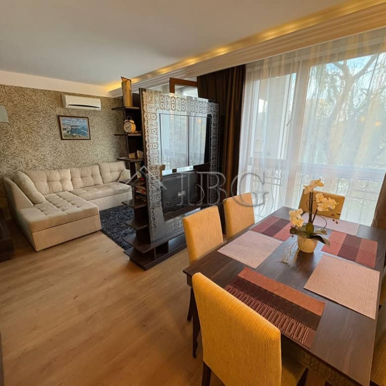 Interior view of a 2-bedroom apartment with living area and dining space in Harmony Palace, Sunny Be.