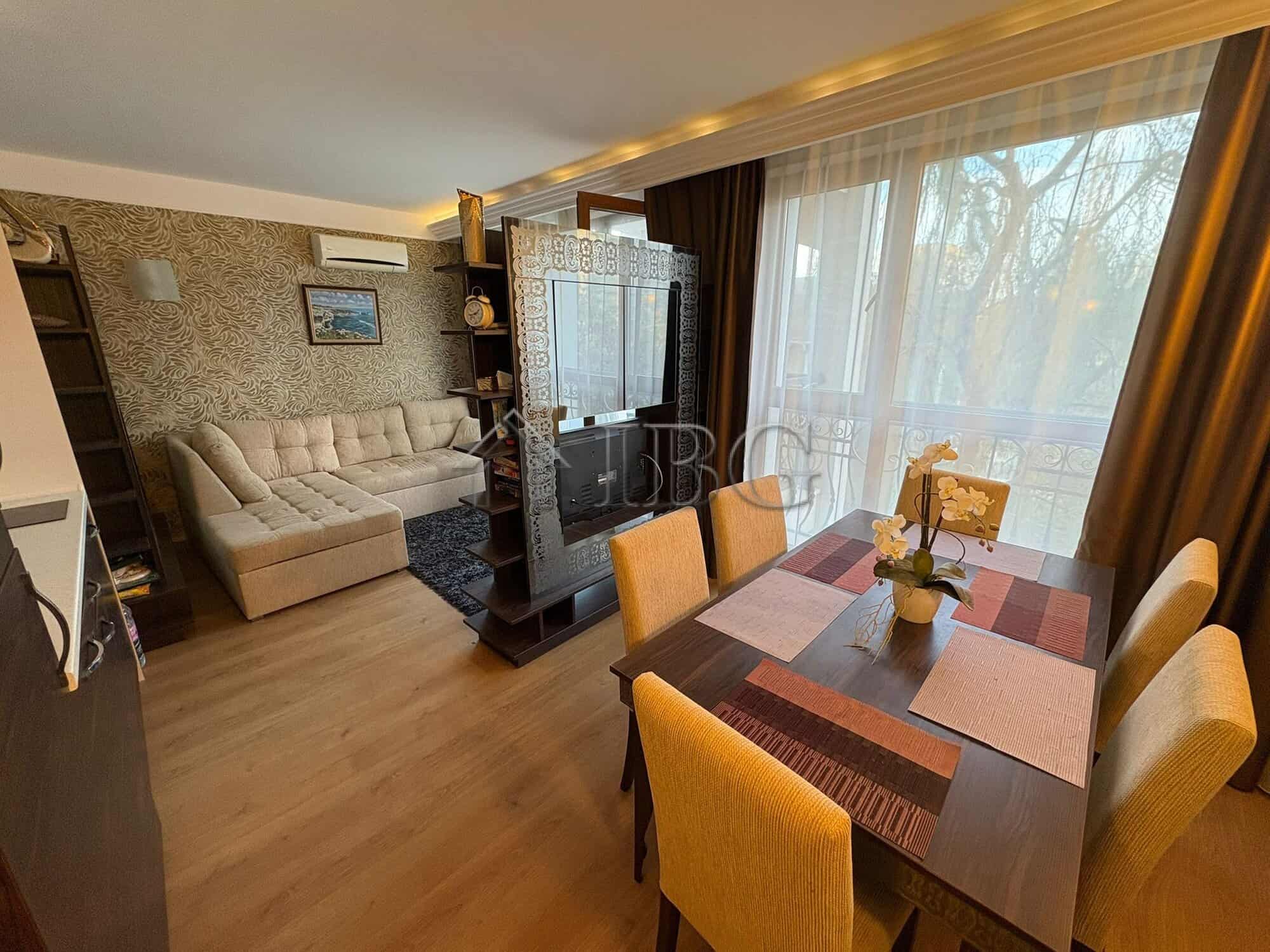 Interior view of a 2-bedroom apartment with living area and dining space in Harmony Palace, Sunny Be.