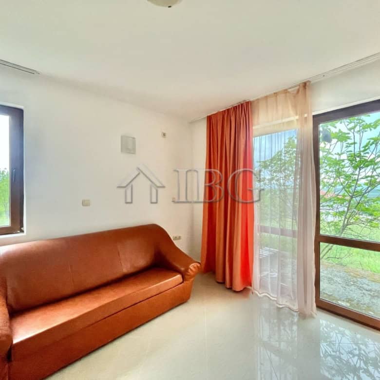 Bright living room with large windows and balcony access, offering scenic views in Aleksandrovo, Bur.