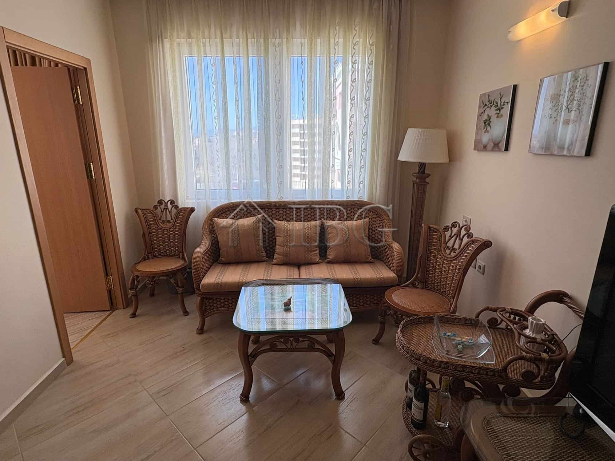 Bright living room with elegant furniture and large window in Majestic Beach Resort, Sunny Beach.