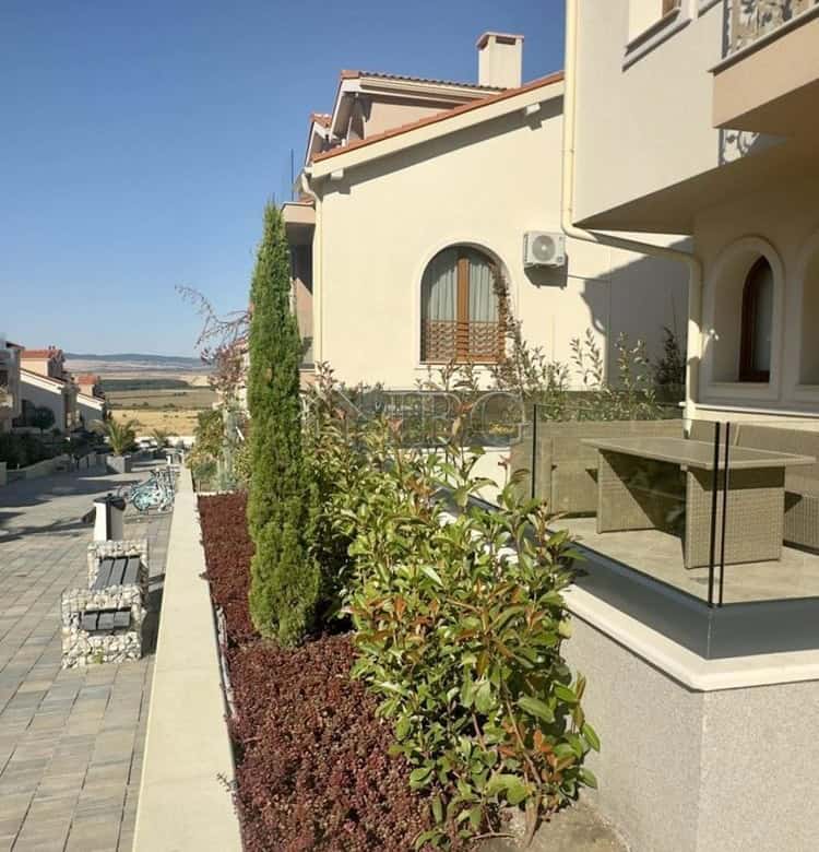 Modern apartment with landscaped garden and large terrace.