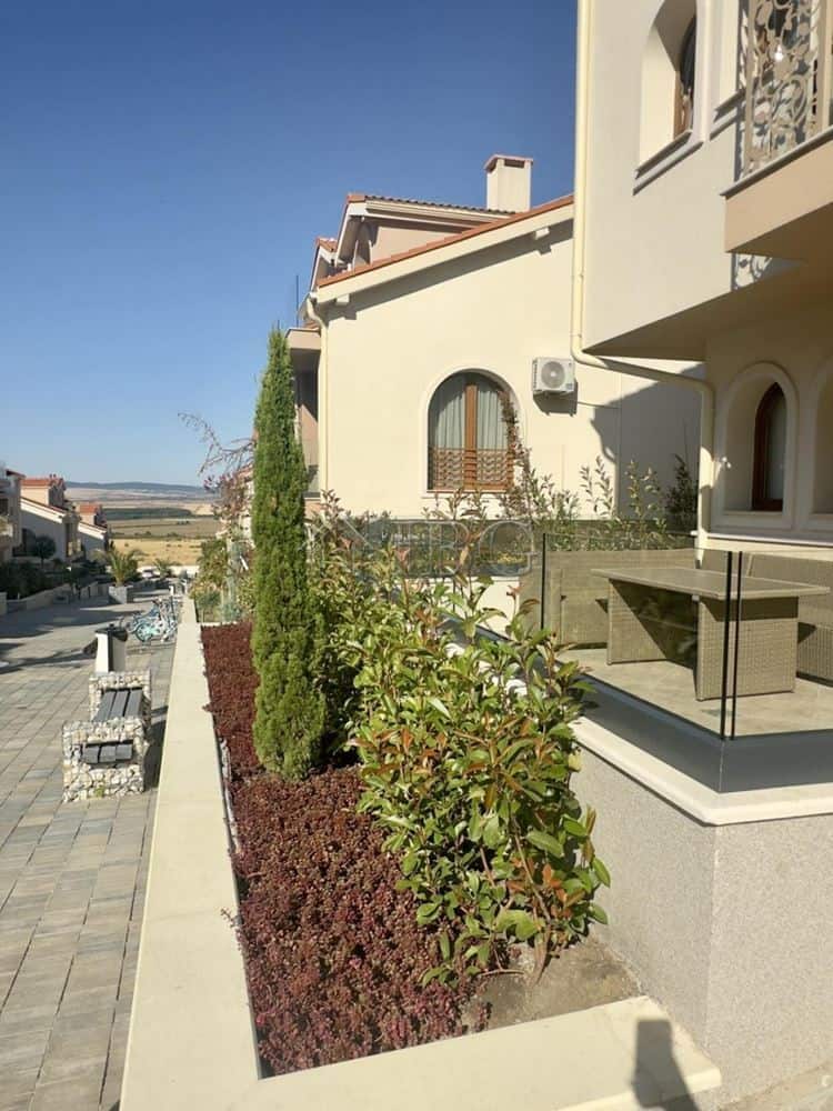 Modern apartment with landscaped garden and large terrace.