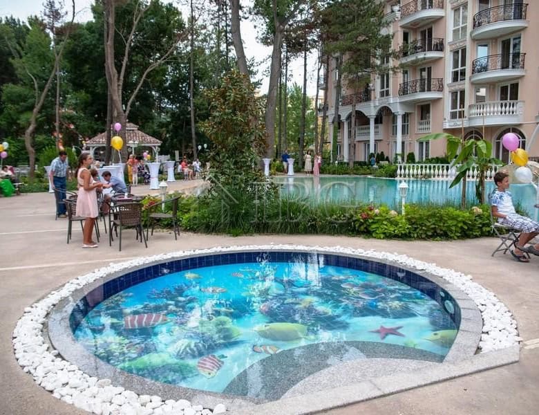 Beautiful pool area at Venera Palace with a children’s pool and outdoor seating in Sunny Beach.