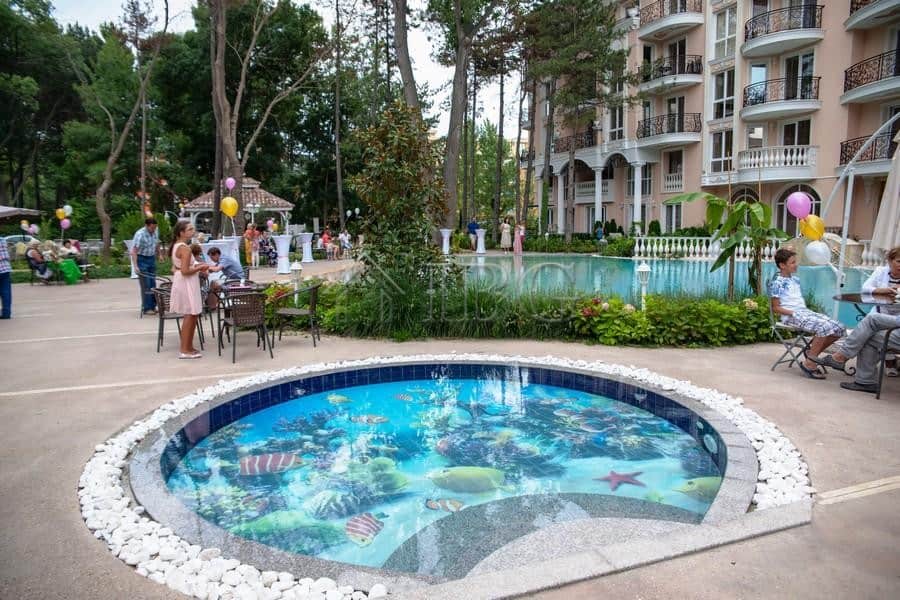 Beautiful pool area at Venera Palace with a children’s pool and outdoor seating in Sunny Beach.