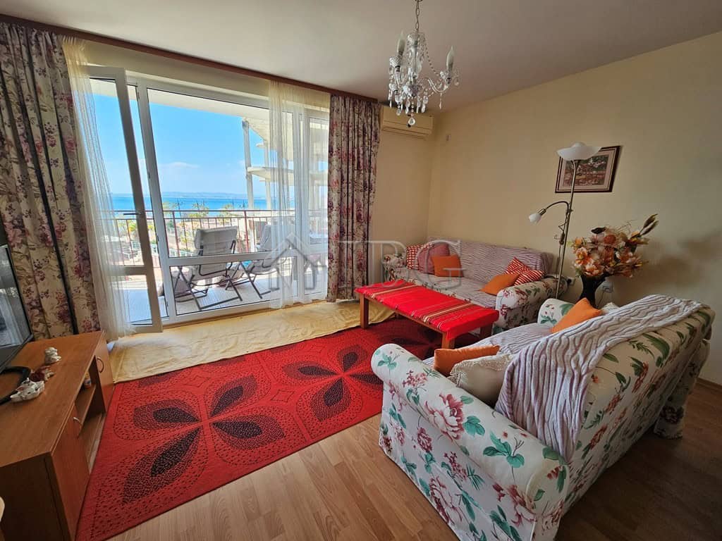 Sea view living room with balcony overlooking the beach and ocean.