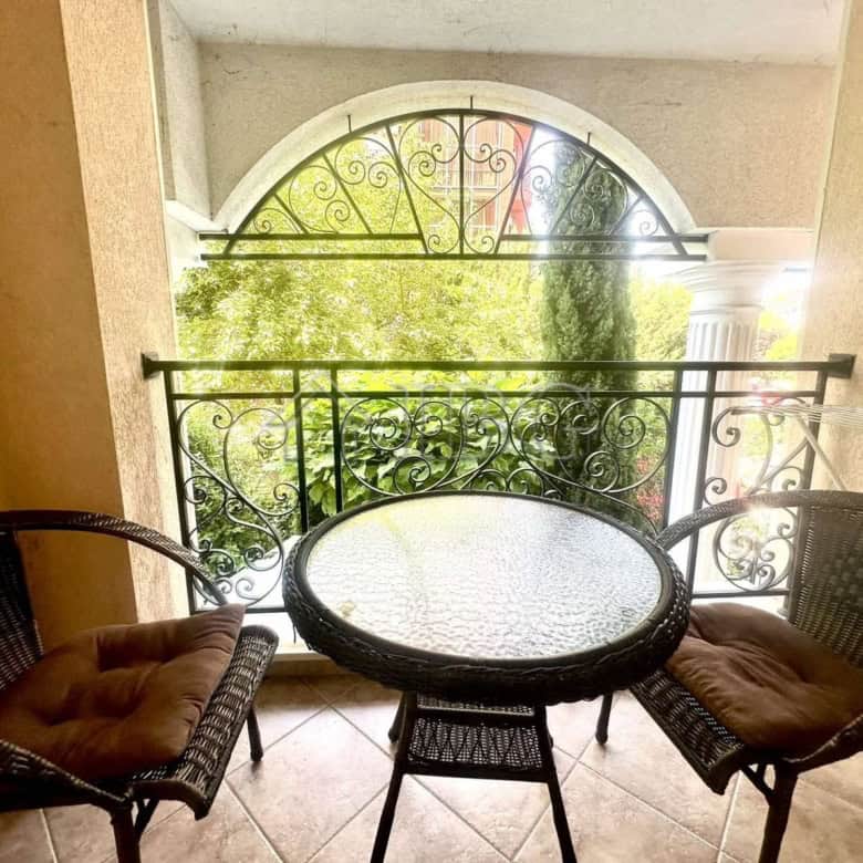 Balcony view of lush greenery and ornate balcony railing in Sunny Beach, Bulgaria.