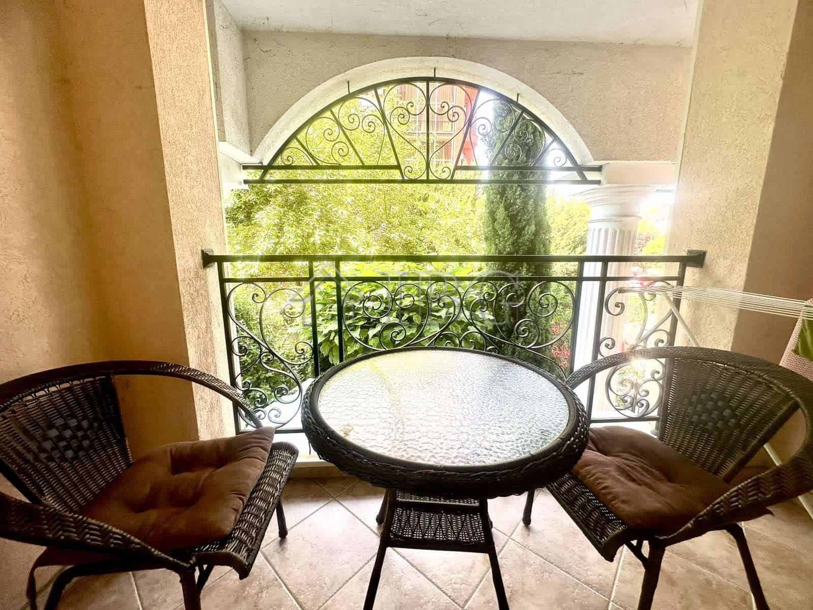 Balcony view of lush greenery and ornate balcony railing in Sunny Beach, Bulgaria.