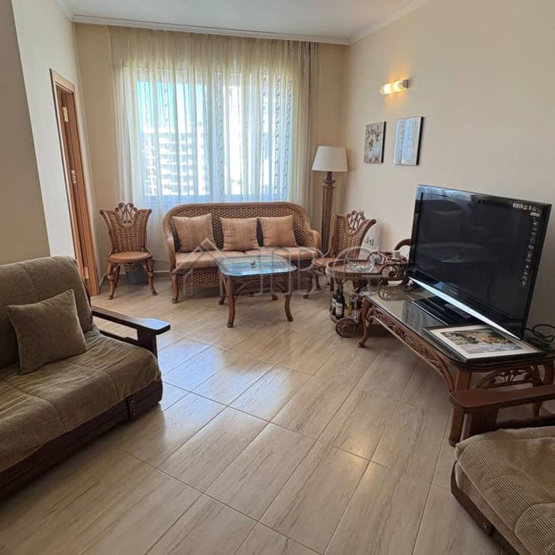 Bright living room with comfortable seating and modern amenities.