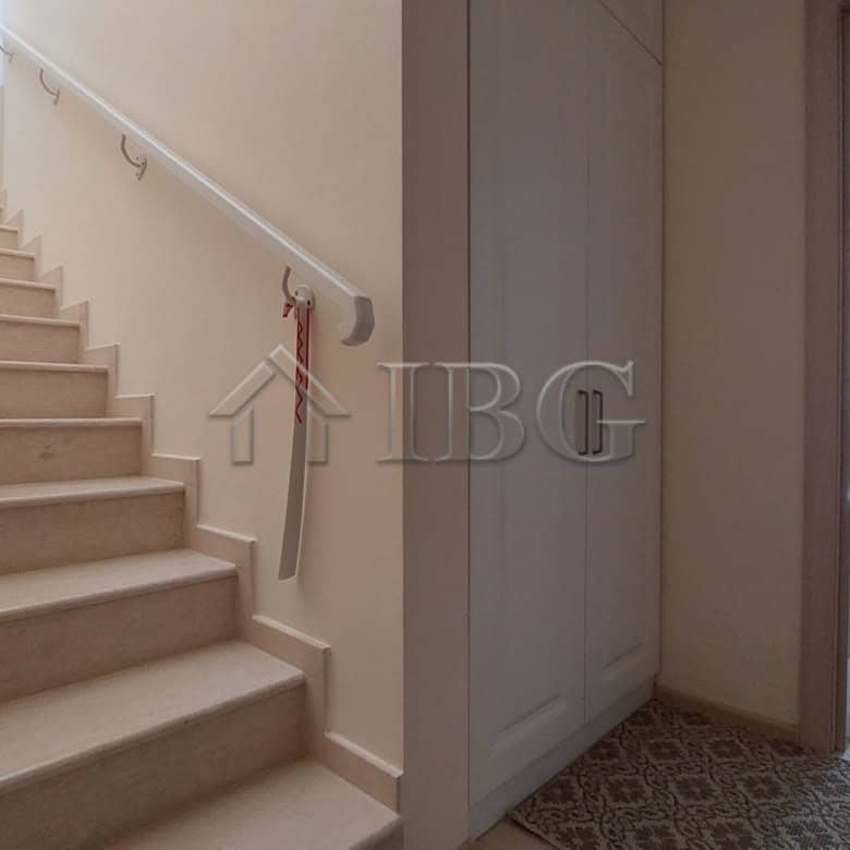 Interior view of a modern two-storey townhouse in Sarafovo, featuring a staircase and living area.