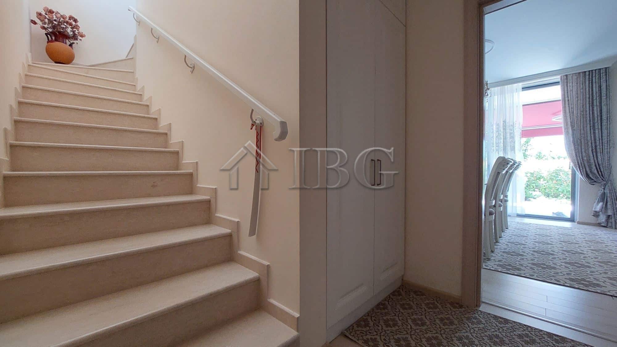 Interior view of a modern two-storey townhouse in Sarafovo, featuring a staircase and living area.