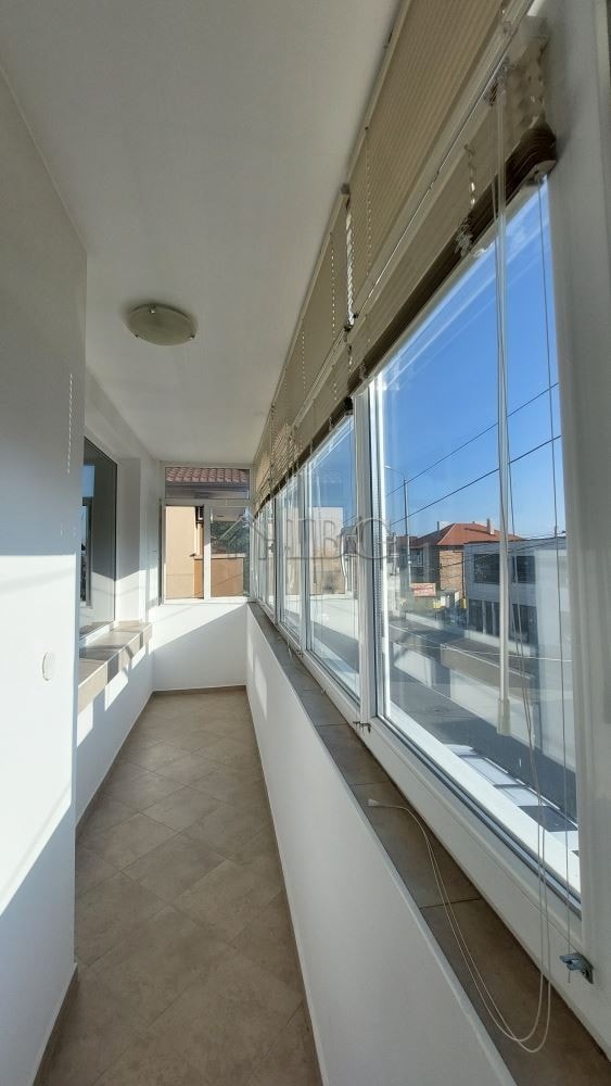Enclosed balcony with large windows in a family house in Burgas, offering bright, airy space.
