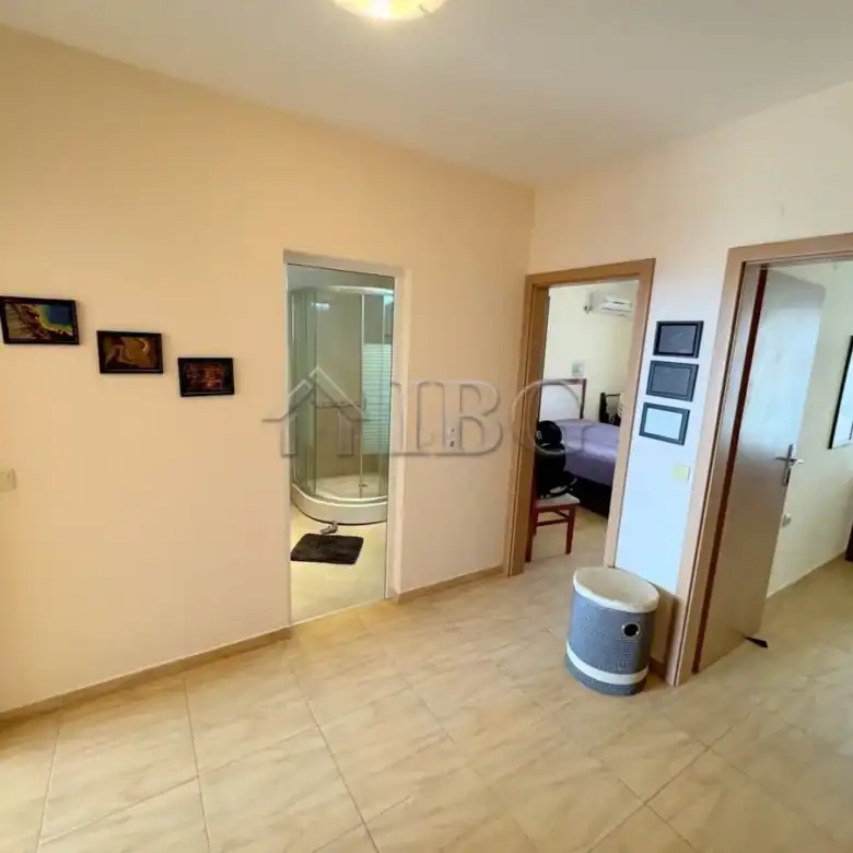 Bright interior with open living space and access to bathroom and bedroom.