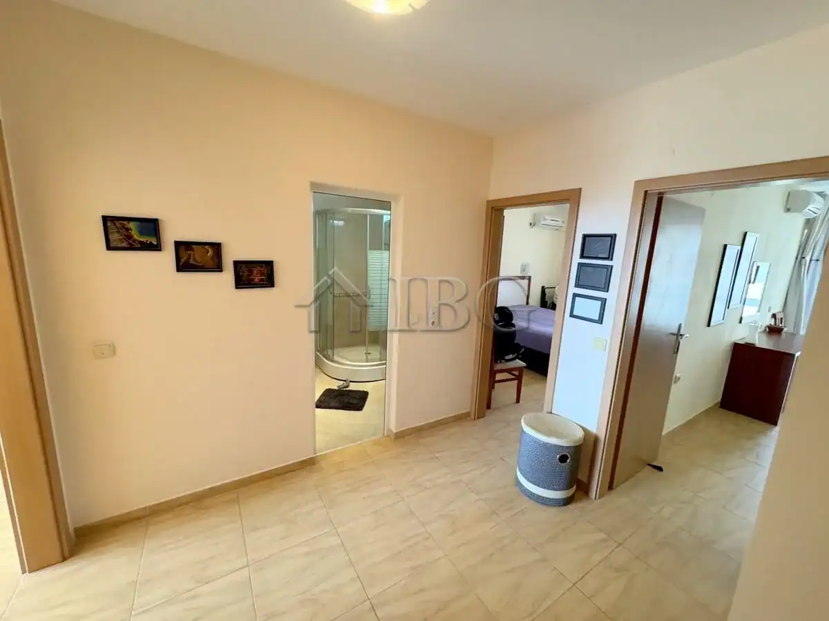 Bright interior with open living space and access to bathroom and bedroom.