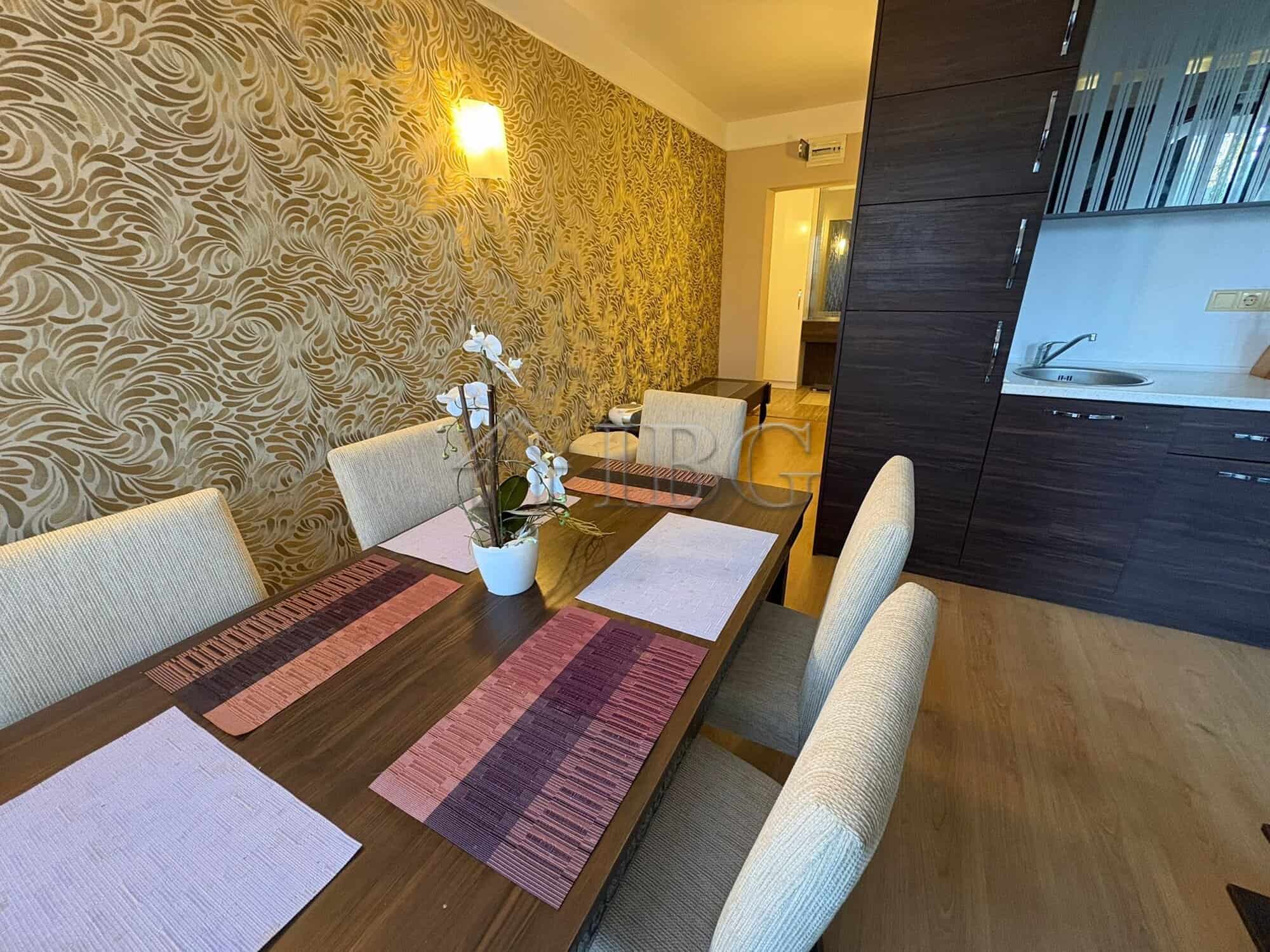 Spacious dining room featuring a stylish table, six chairs, and decorative wallpaper in a luxury apa.