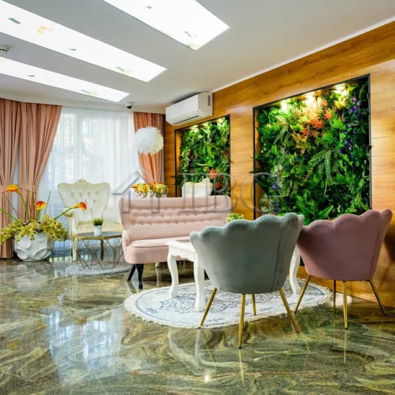 Bright living room with modern furniture and green wall accents.