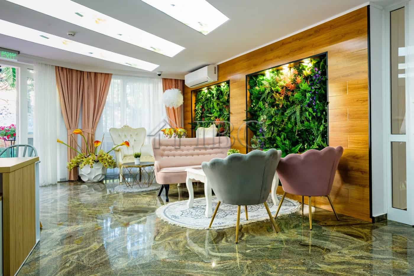 Bright living room with modern furniture and green wall accents.