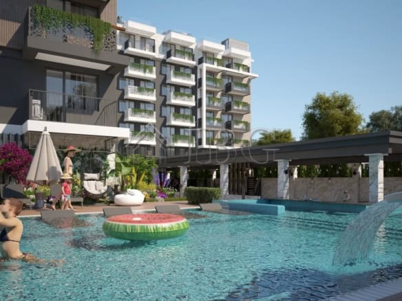 Contemporary apartment building with swimming pool and lush garden area in Sunny Beach.