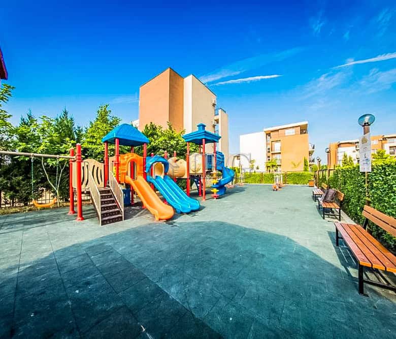 Bright outdoor playground with slides and climbing structures at Orchid Fort Club, Sunny Beach.