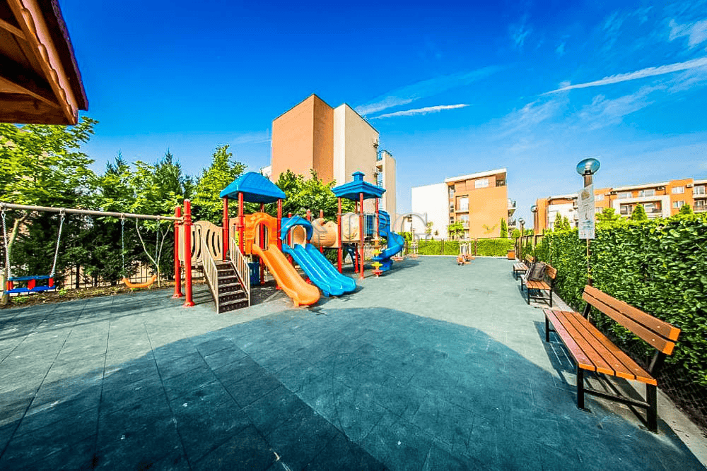 Bright outdoor playground with slides and climbing structures at Orchid Fort Club, Sunny Beach.