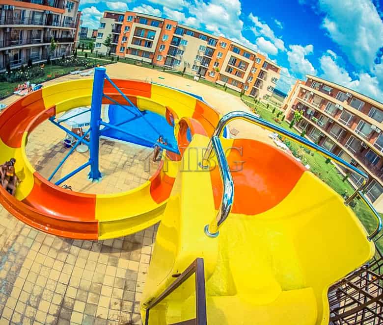 Water slide with pool view at Orchid Fort Club, Sunny Beach. Perfect for family fun and relaxation i.