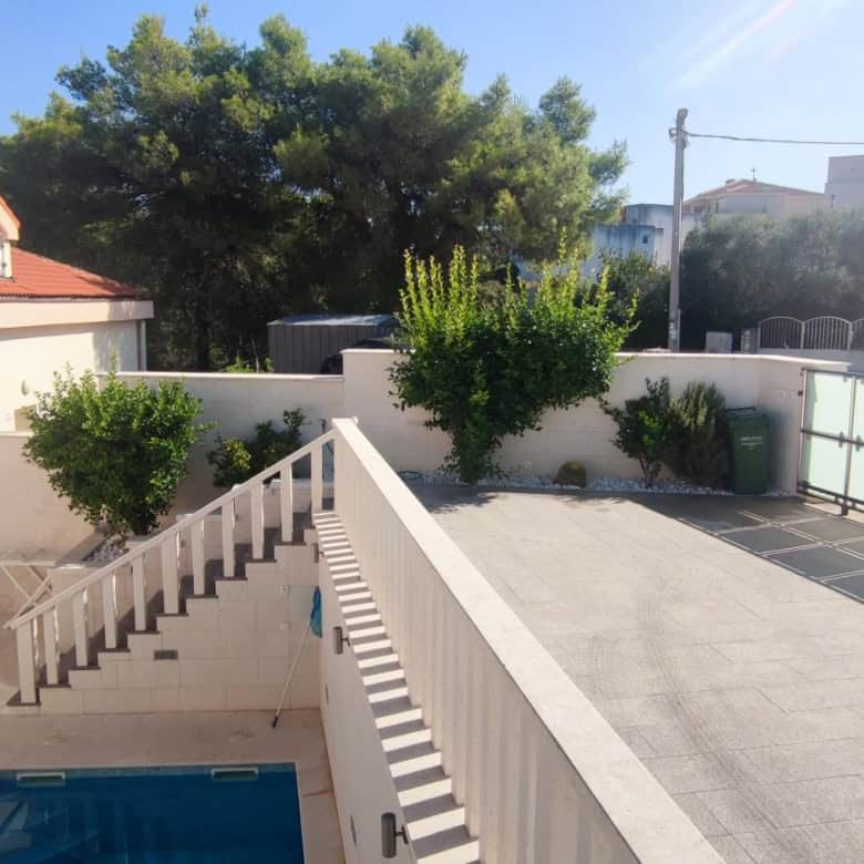 Spacious apartment in Okrug Donji with private terrace and pool view.